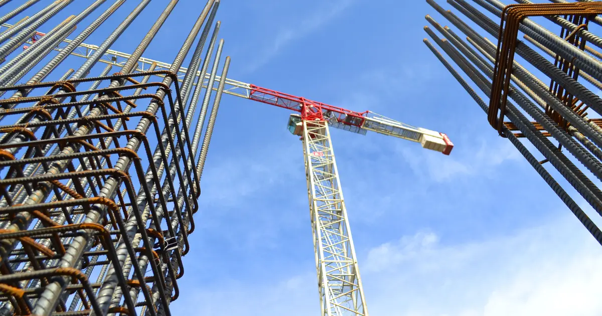 Steel structure and tower crane on site during the early stages of building construction
