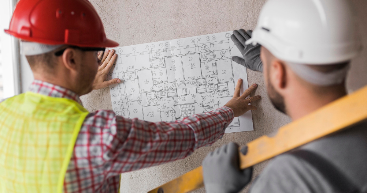 Construction workers reviewing building construction plans